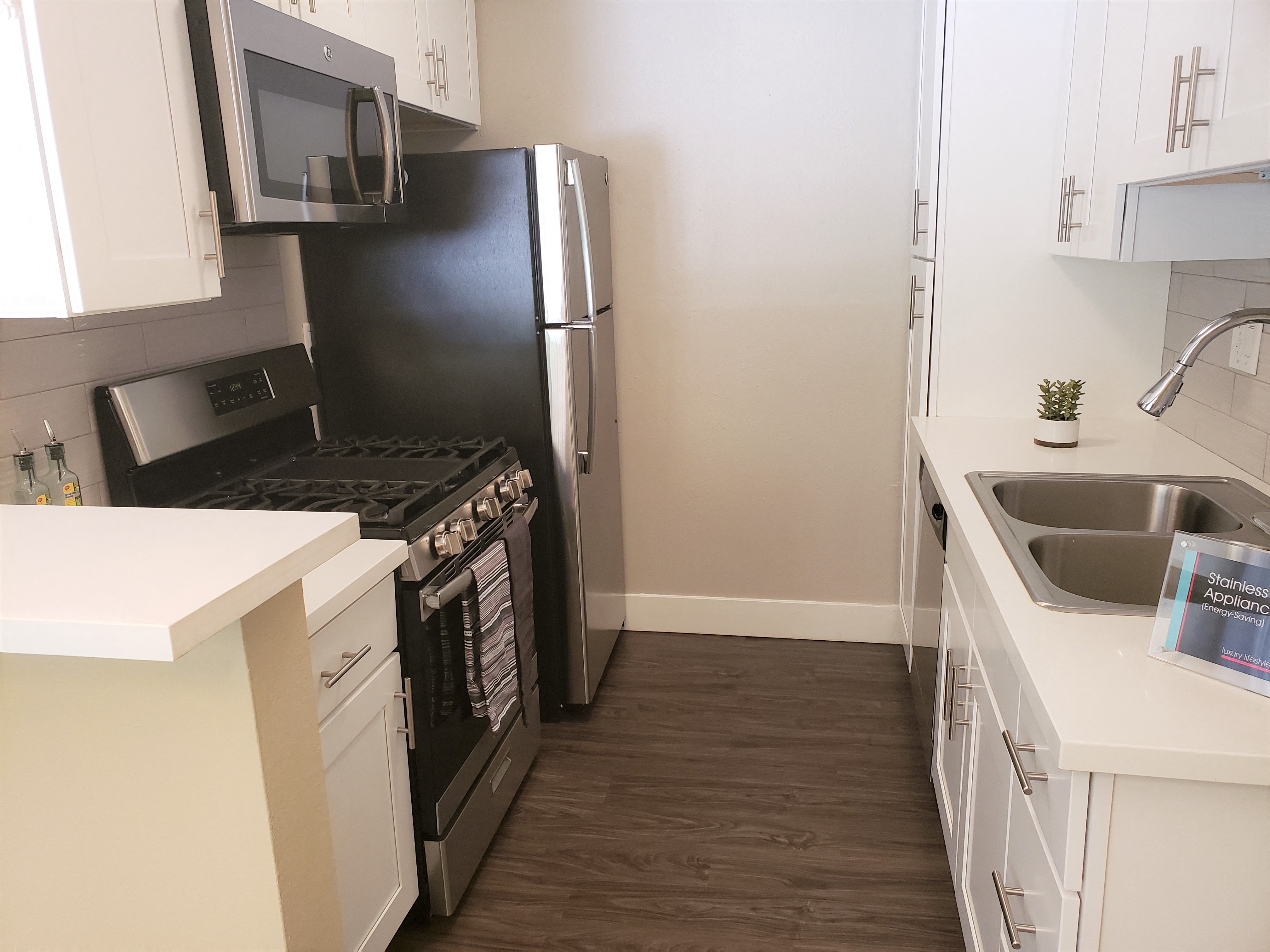 Kitchen with all modern stainless steel appliances at the Ebony 2BR/2BA